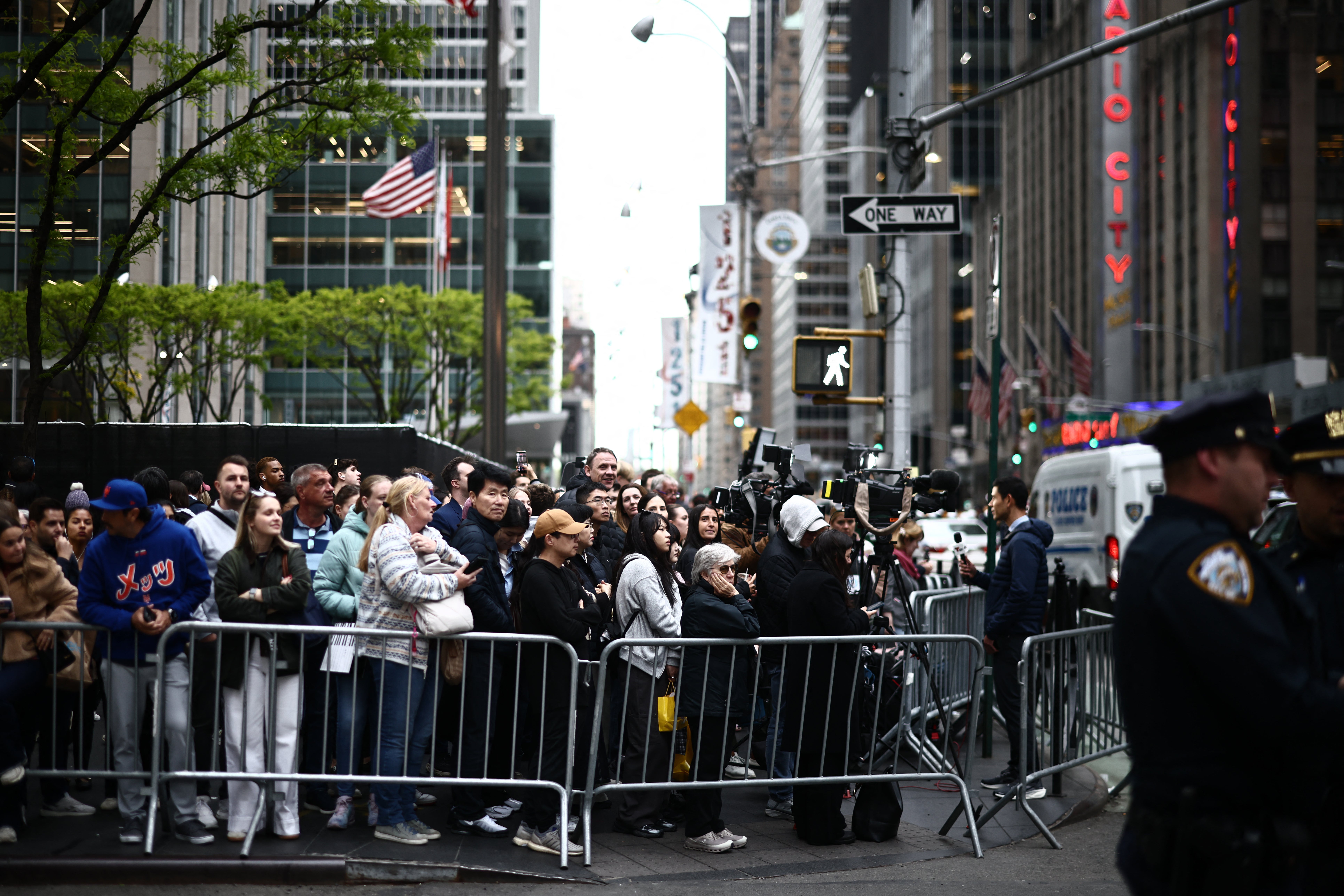 People gather in the street as Britain's King Charles III and Queen Camilla attend the Greater Together Reception, partner of King's Trust at Christie's in New York