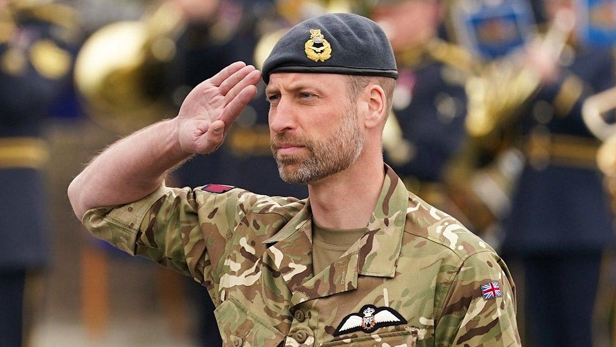 Prince William saluting during a visit to RAF Valley in Anglesey