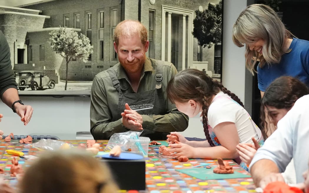 Britain's Prince Harry (C), Duke of Sussex, takes part in a model making activity with veterans and their families at the Australian National Veterans Arts Museum (ANVAM), in Melbourne on April 14, 2026.