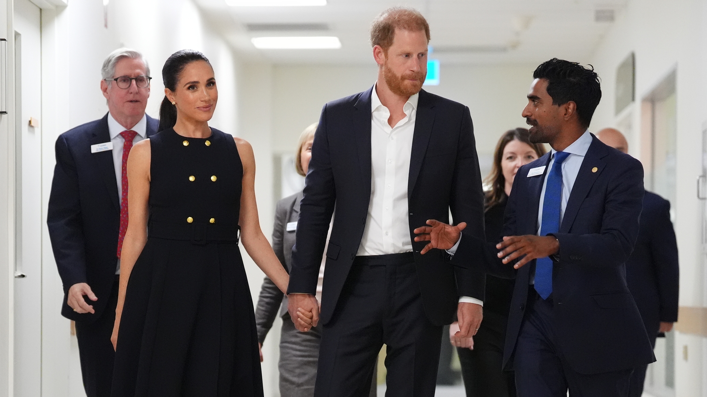 Meghan, Duchess of Sussex and Prince Harry talk with Kog Ravindran, chief of staff to the CEO &amp; executive director of communications at the Royal Children's Hospital