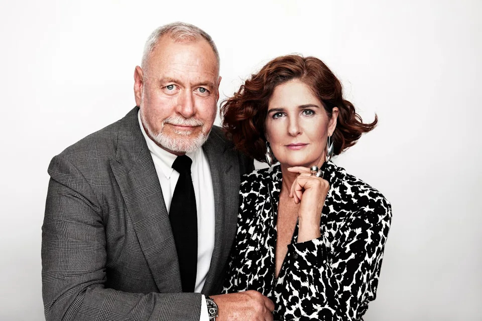 A formal portrait of two adults dressed elegantly, posed closely together.