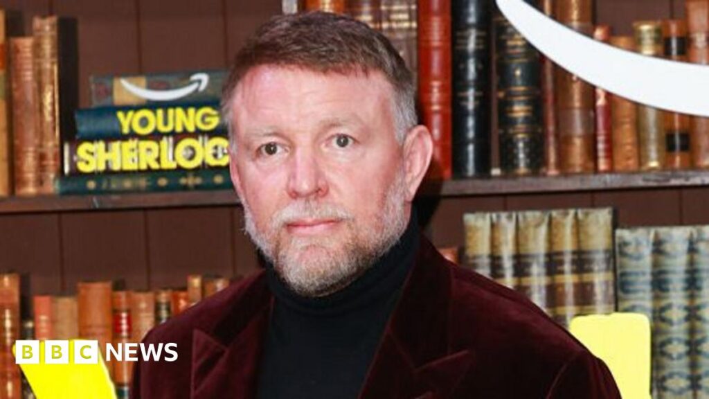An interior image of Llandaff Cathedral, with a camera boom and sound equipment next to pews.