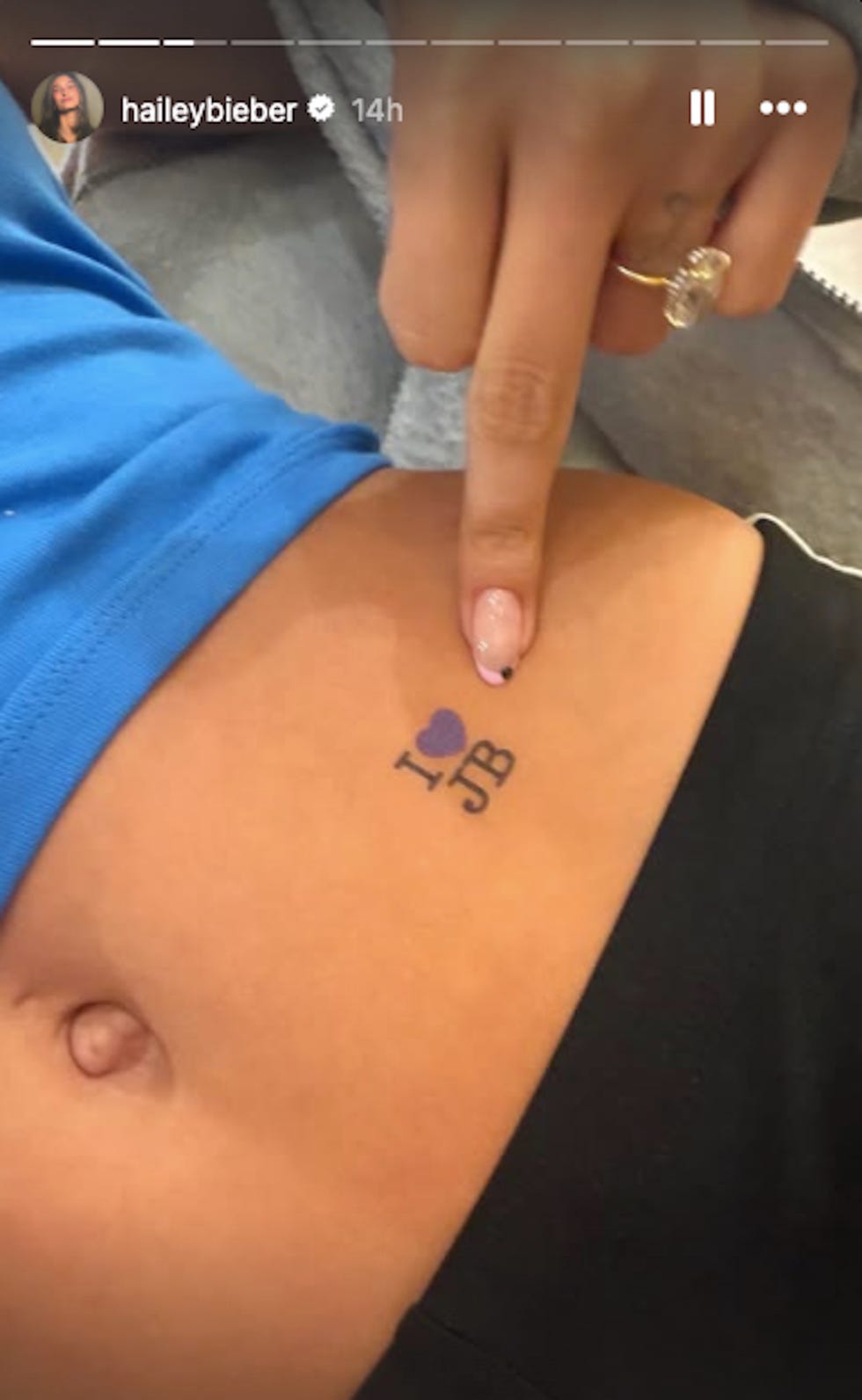 Tattoo on the abdomen indicating affection for 'JB.'