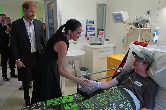 Britain's Prince Harry and Meghan Markle, the Duke and Duchess of Sussex, meet patient Hamish on the Adolescent Oncology and Rehabilitation ward during a visit to the Royal Children's Hospital Melbourne, Australia