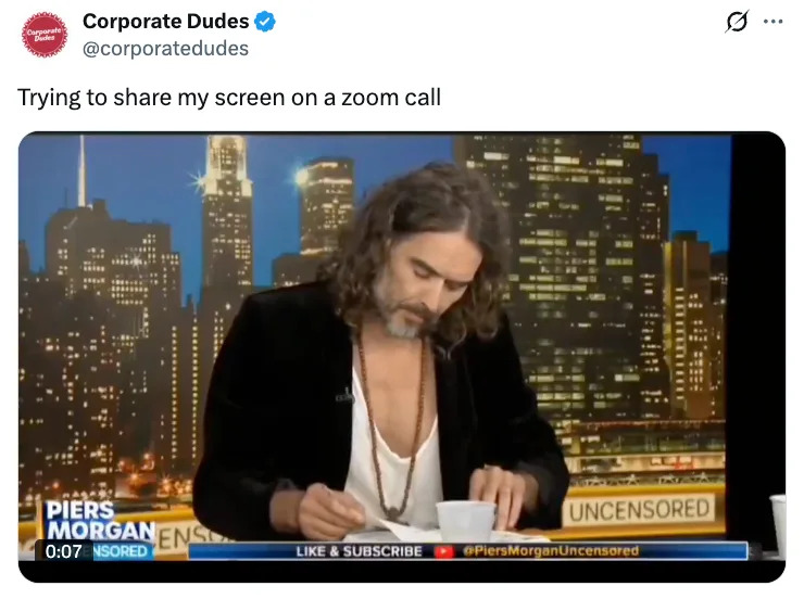 Man with long hair struggles with a device on a TV show set, captioned as "Trying to share my screen on a Zoom call."