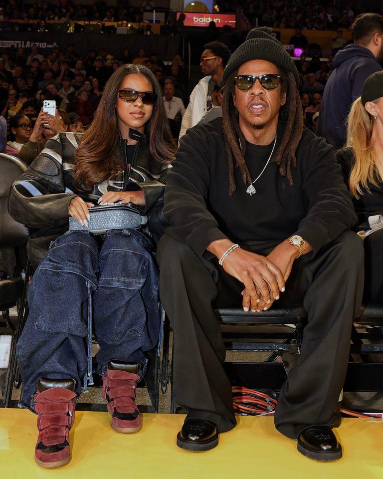 Jay-Z (R) with daughter Blue Ivy at a December 2025 Lakers game.Credit: Jim Poorten/NBAE via Getty Images