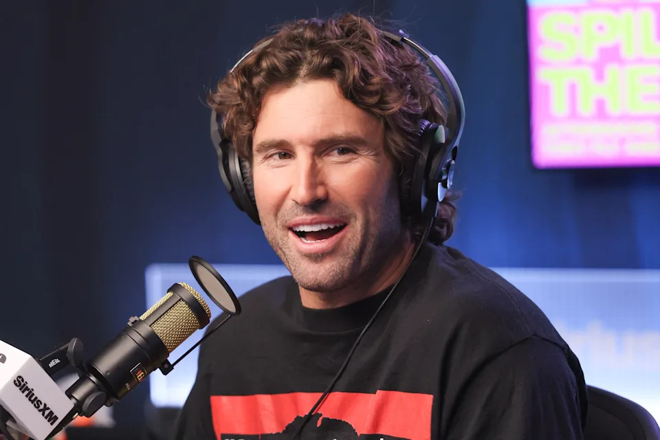 Person wearing headphones speaks into a microphone during a radio show