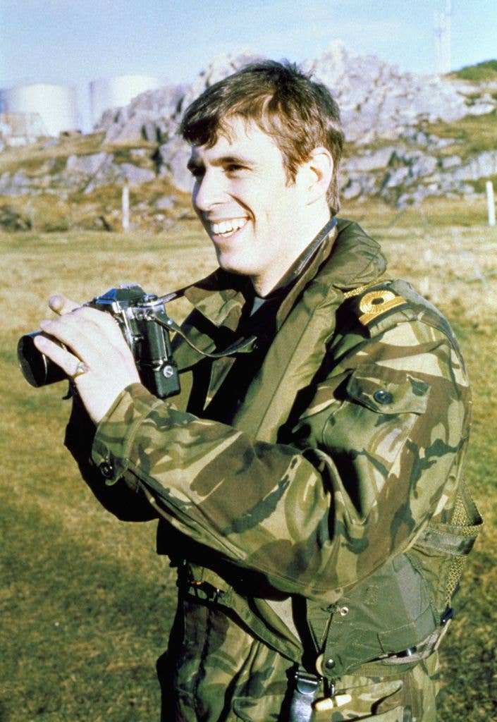 young prince andrew in military gear holding camera
