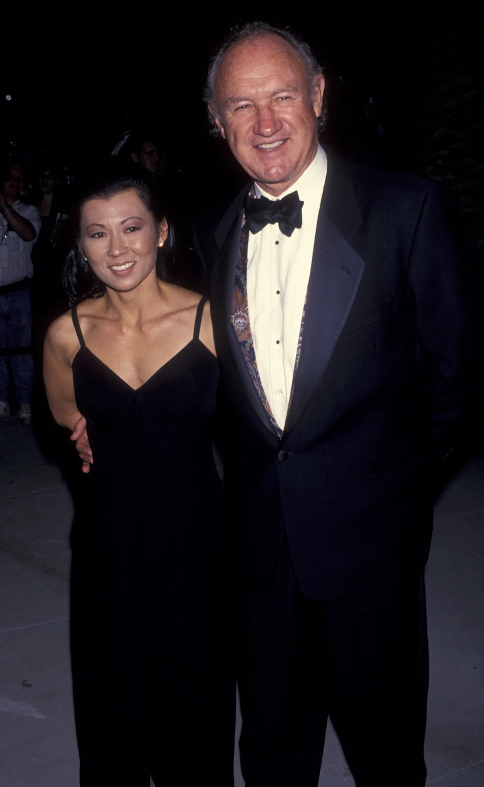Gene Hackman and Betsy Arakawa smile in formal attire