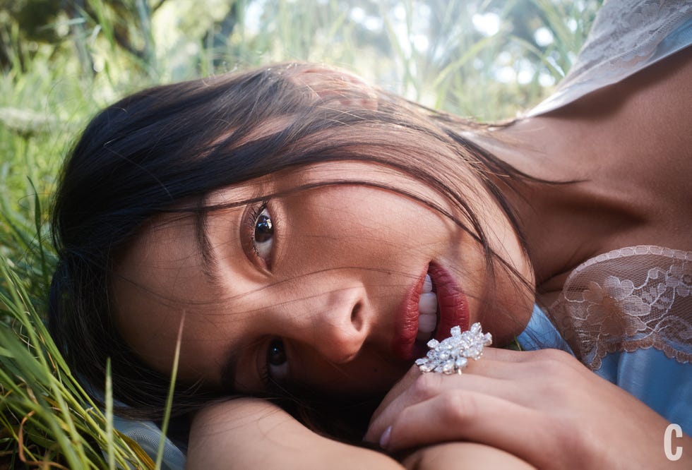 Person resting in grass with partial view of arm and shoulder.