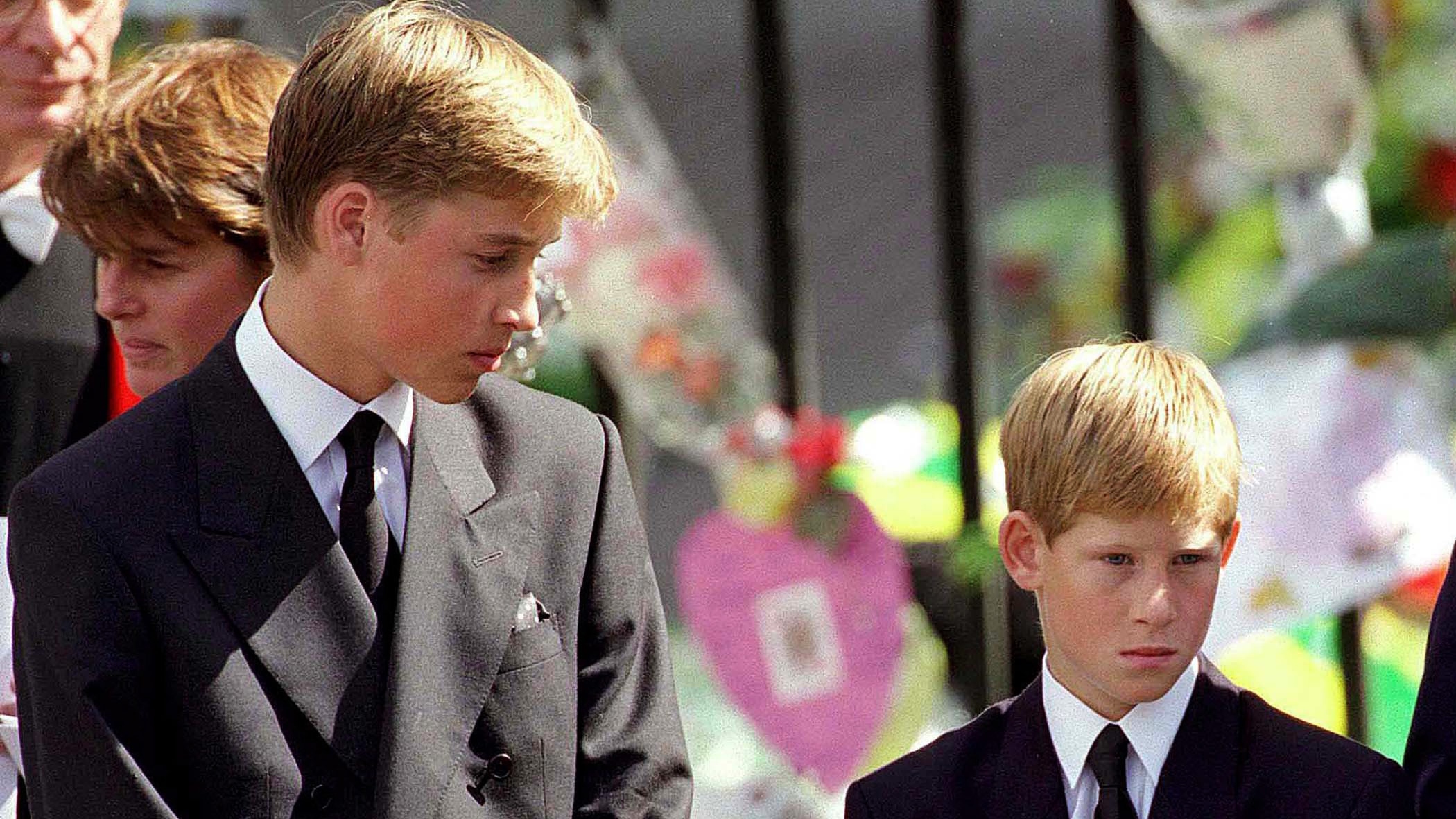 Prince William and Prince Harry stand outside Westminster Abbey at the funeral of Diana, Princess of Wales on September 6, 1997 in London