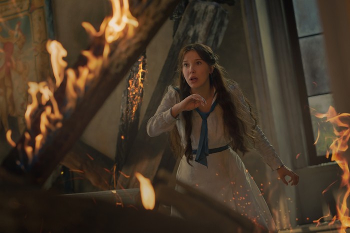 A woman in a burning building.