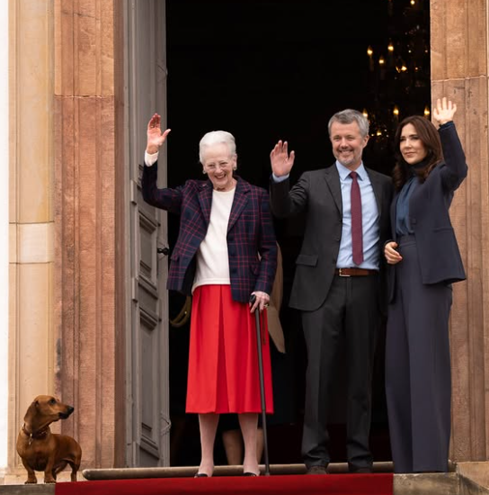 Queen Margrethe waves with King Frederik and Queen Mary