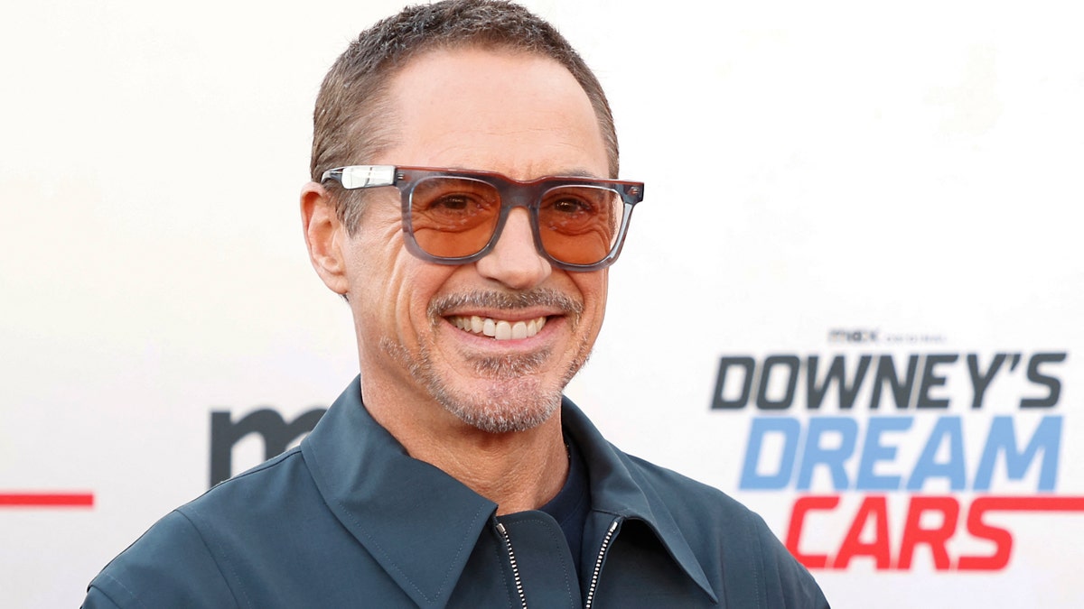 Robert Downey Jr. wearing sunglasses on the red carpet at Petersen Automotive Museum