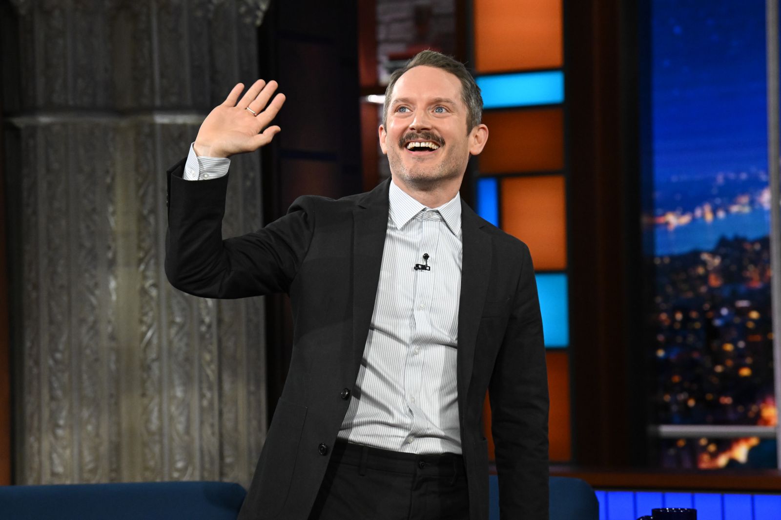 Image may contain Elijah Wood Blazer Clothing Coat Jacket Formal Wear Suit Head Person Face Adult and People