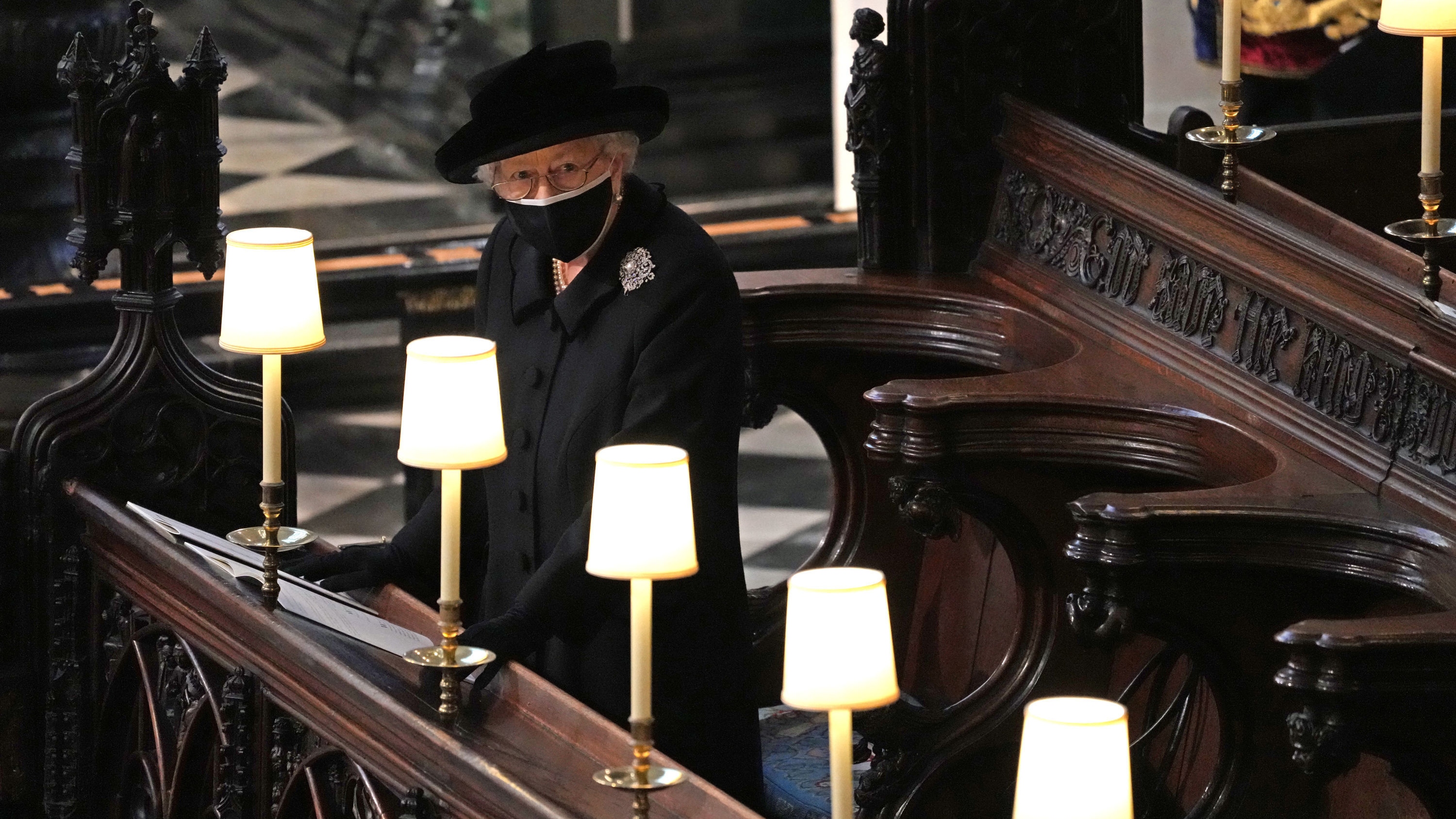 Queen Elizabeth II watches as pallbearers carry the coffin of Prince Philip, Duke Of Edinburgh into St George&rsquo;s Chapel during his funeral at Windsor Castle on April 17, 2021