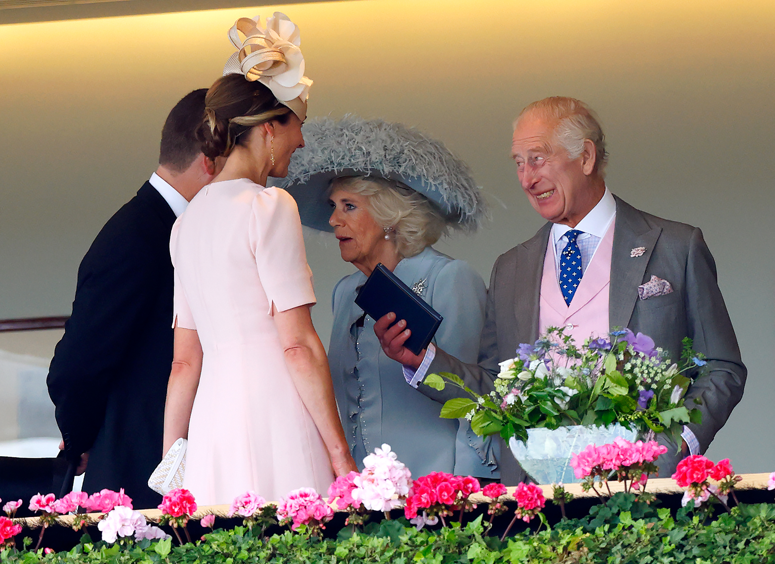 Harriet Sperling and Peter Phillips talking to The King and Queen in the royal box at Ascot