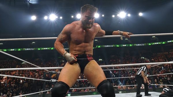 A professional wrestler, MJF, is in the ring during a match at AEW Dynasty, concealing the Dynamite Diamond Ring in his trunks. He is shirtless and has an intense expression on his face, with the crowd visible in the background.