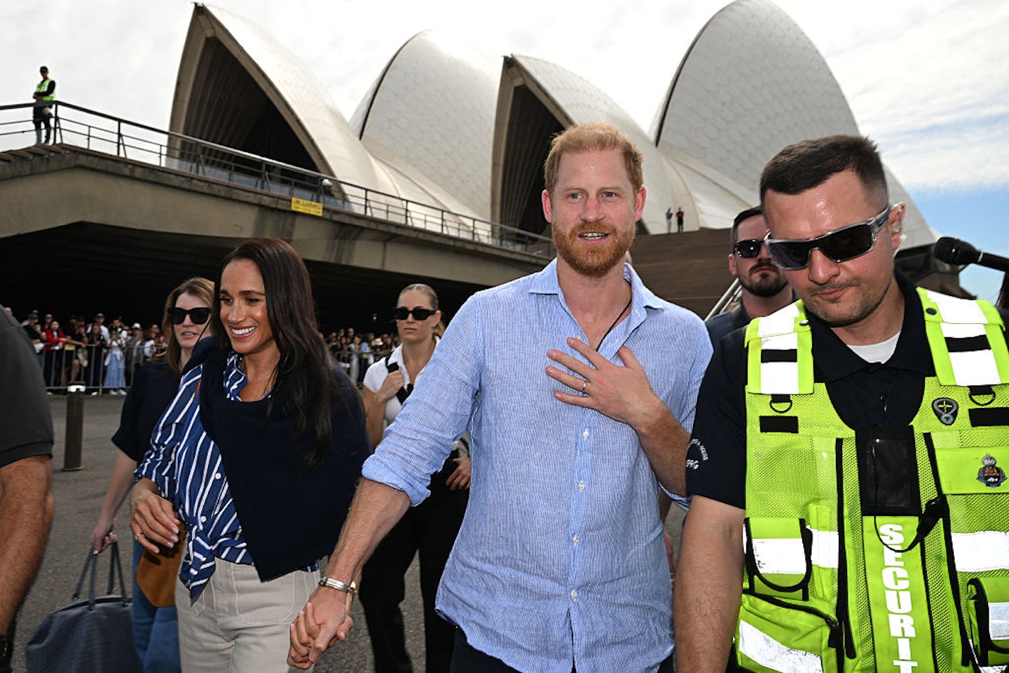 Prince Harry and his wife Meghan, walk towards the wharf to board a sailing boat at Australia's iconic Sydney Opera House