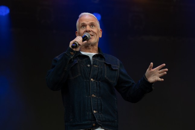 ESSEX, UNITED KINGDOM - 2025/08/02: Chris Moyles see introducing bands on to the stage at music festival. Heritage Live music festival was held at The Audley End Estate in Essex. Bands playing were Ash, The Charlatans and The Manic Street Preachers, Opening and the day was a DJ set from Chris Moyles who then hosted the days event by introducing the bands to the stage. (Photo by Bonnie Britain/SOPA Images/LightRocket via Getty Images)