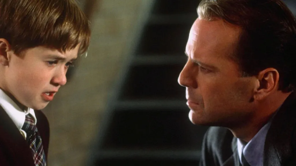 Bruce Willis and Haley Joel Osment share a scene in The Sixth Sense