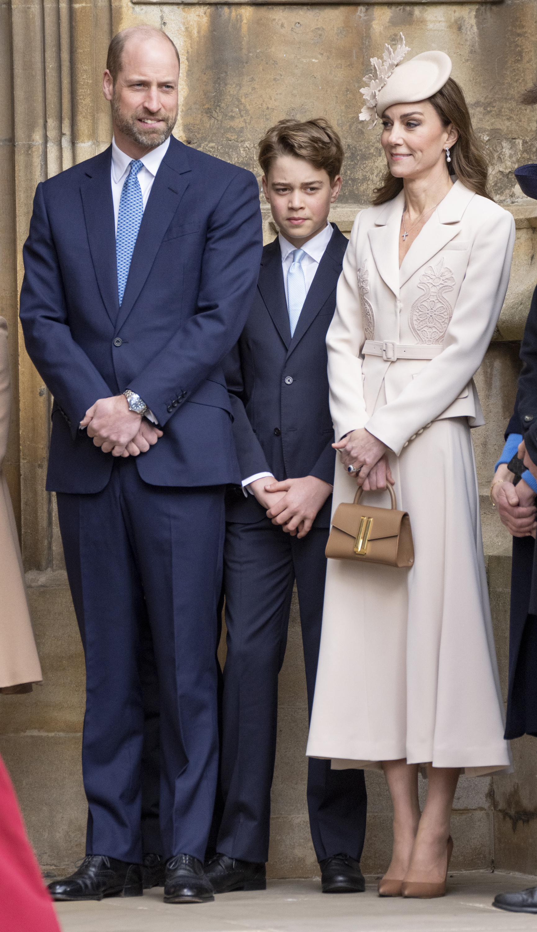 Prince William and Prince George wear deep navy suits with blue ties, while Princess Kate, the Princess of Wales, wears a cream Self-Portrait dress and matching hat to attend the 2026 Easter Service