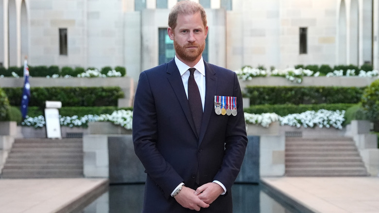 Prince Harry standing wearing military medals