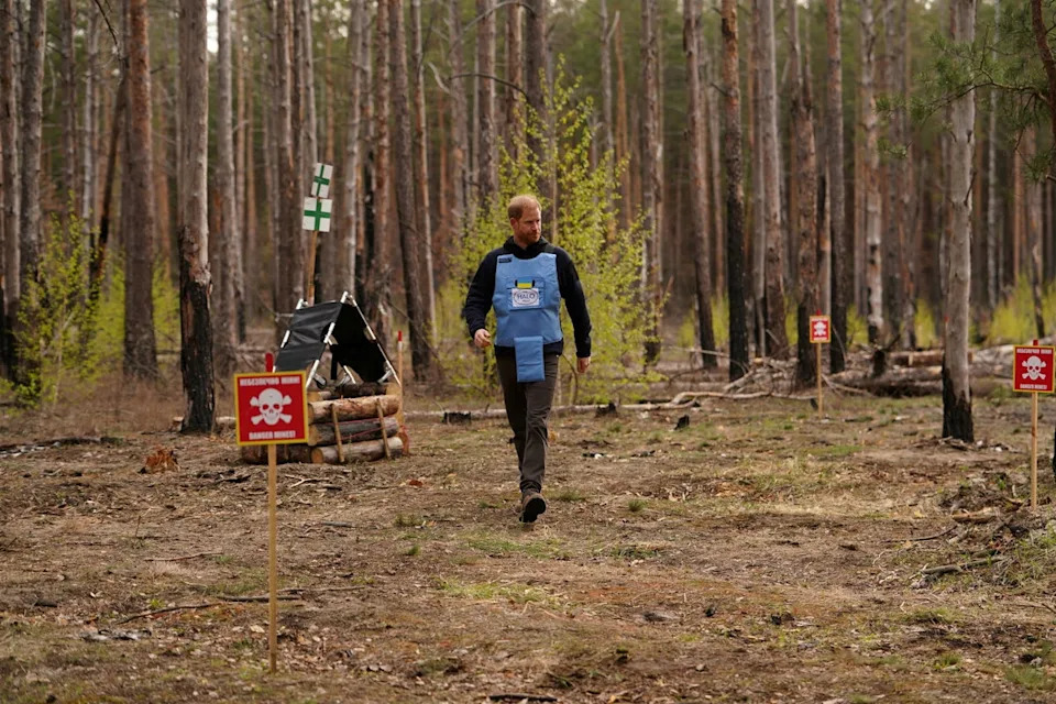 Britain's Prince Harry, the Duke of Sussex, walks in a forest as he visits members of the HALO Trust (Hazardous Area Life-support Organization), a non-commercial charity organisation for demining (Reuters)