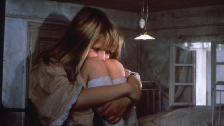 Kristýna Kohoutová as Alice is scrunched into a miniature house in Alice