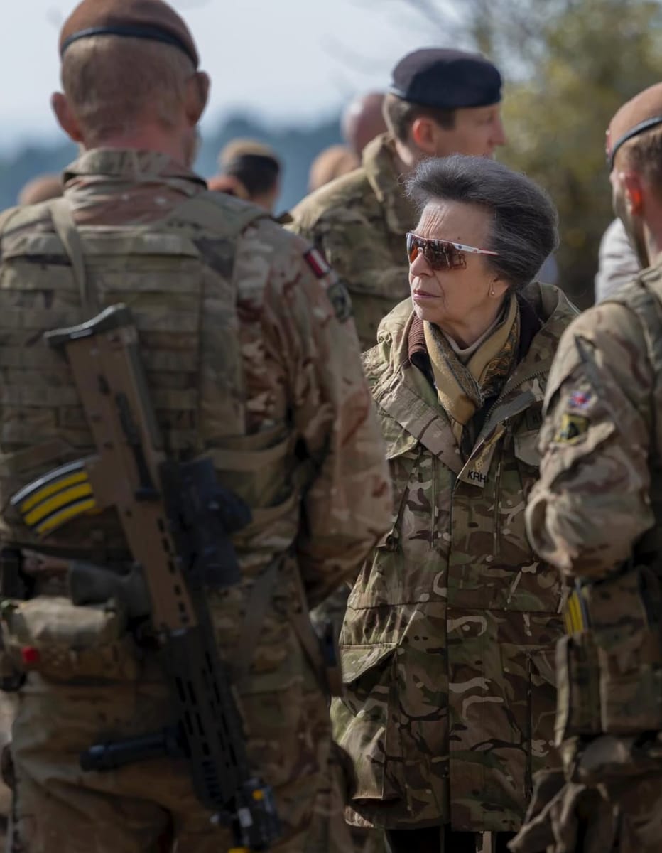 Dressed in full combat uniform and sunglasses, Princess Anne gets hands-on with troops during NATO preparation exercises.
