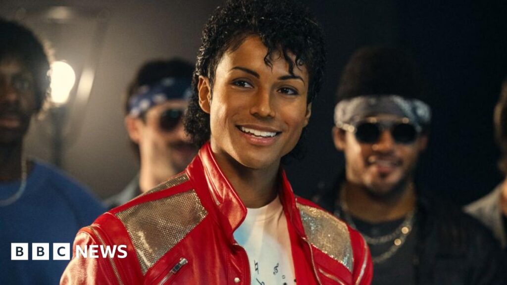 Jaafar Jackson as Michael Jackson in the musical biopic Michael, wearing a red and silver jacket