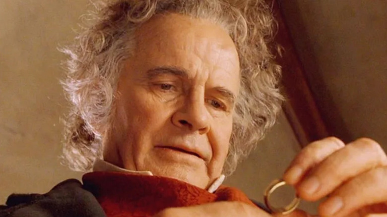 Bilbo Baggins (Ian Holm) examines the One Ring of Power in The Lord of the Rings: The Fellowship of the Ring