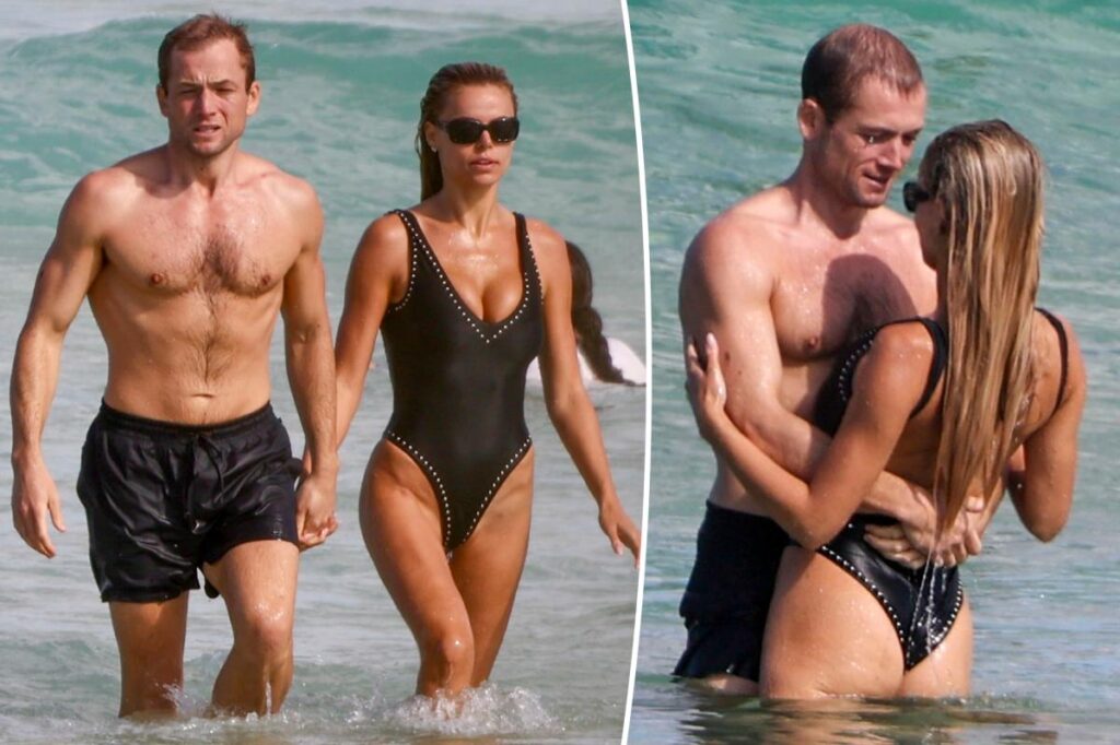 Brooks Nader and Taron Egerton take a dip during romantic Australia beach date