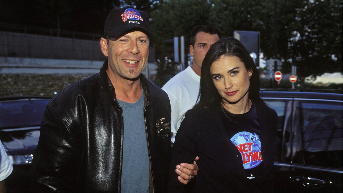 Bruce Willis and Demi Moore standing together in Paris