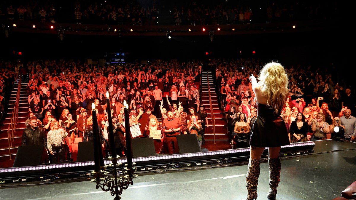 Bunnie XO speaking to an audience.