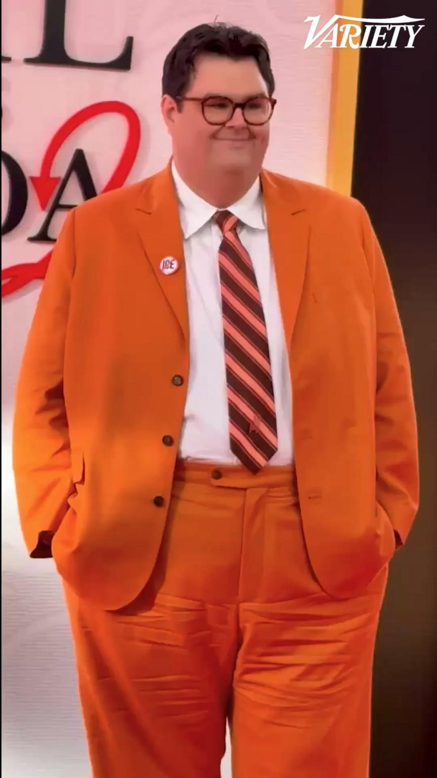 Caleb Hearon wears an “ICE OUT” pin at "The Devil Wears Prada 2" world premiere.