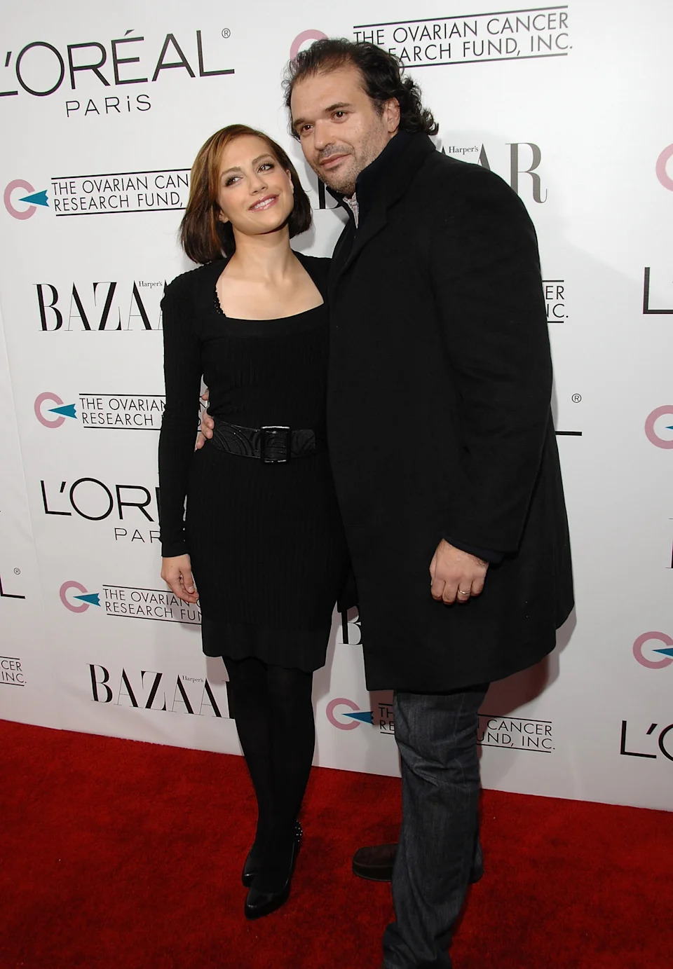 Brittany Murphy in a stylish dress, and Simon Monjack in a coat and jeans on the red carpet