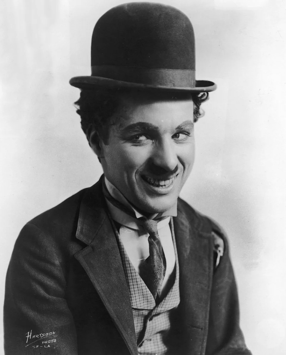 Charlie Chaplin in vintage suit with bowler hat, smiling