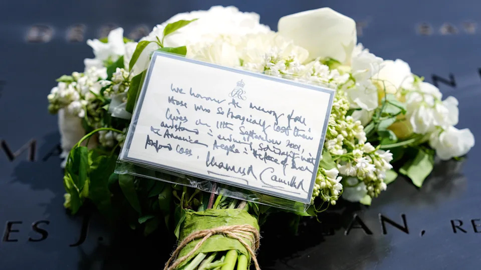Flowers from King Charles III and Queen Camilla are seen at the 9/11 Memorial.
