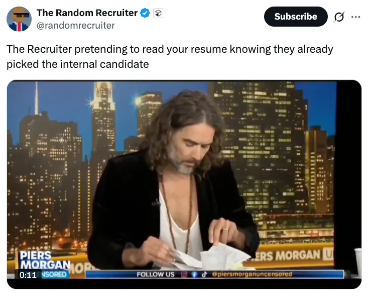 A person humorously pretends to read papers while on a news talk show set, with a cityscape backdrop. Caption jokes about resume biases