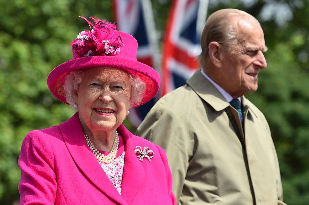 Queen Elizabeth II in pink jacket and hat and Prince Philip beside her