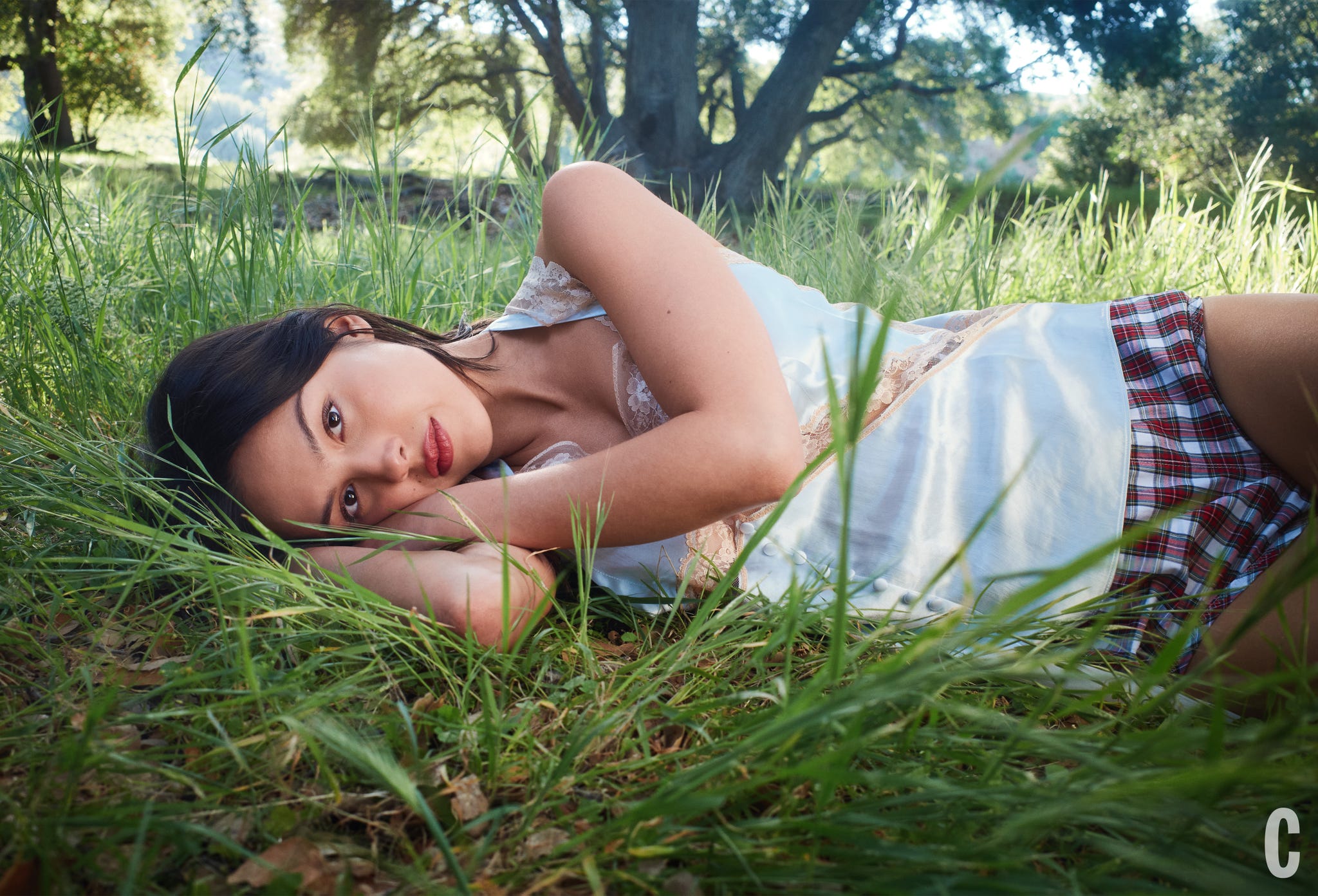 A person lying in a grassy area, seemingly relaxed.