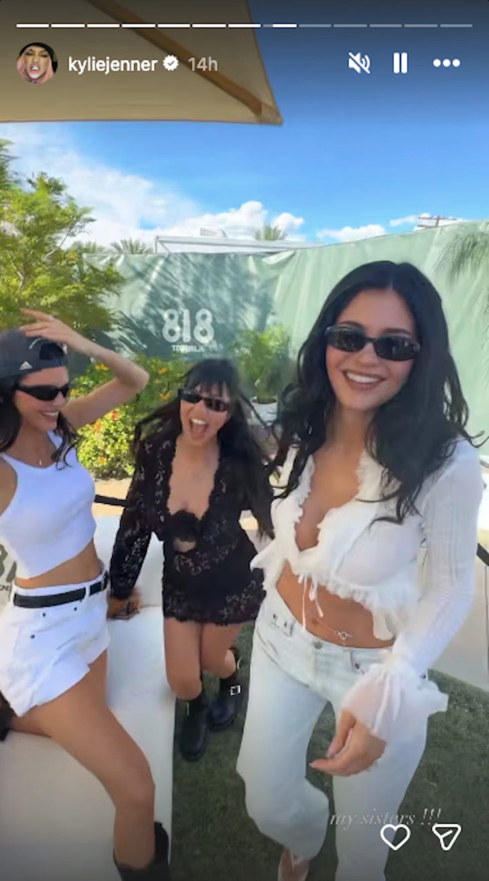 Group of three women posing outdoors in a social setting