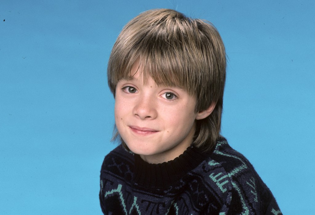 Danny Pintauro from "Who's the Boss?" smiles at the camera in a portrait shot.
