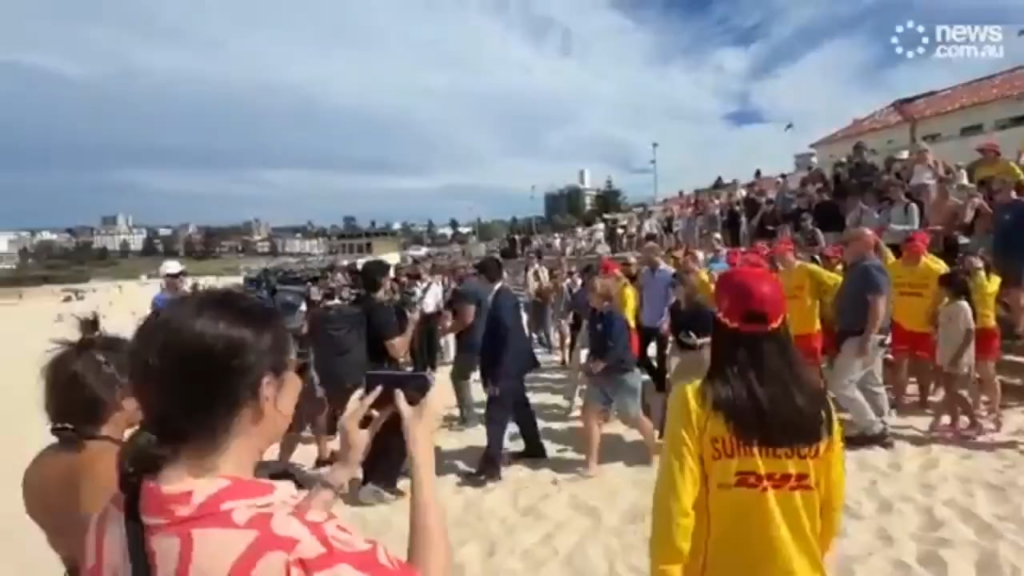 Bondi beach goer give zero f*cks, refuses to move for crowds attending and filming Harry and Meghan, keeps reading her book