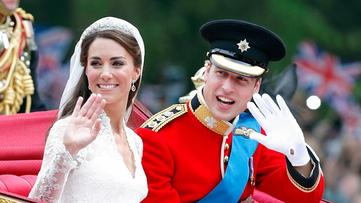 Prince William in red tunic and Catherine Duchess of Cambridge riding in horse-drawn carriage