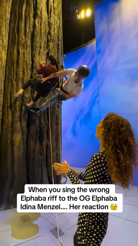 Idina Menzel casually belting the Elphaba Riff from ‘Defying Gravity’ while hanging upside down from a tree