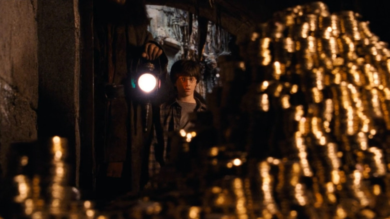 Harry Potter (Daniel Radcliffe) looking at a mountain of galleons in Harry Potter and the Sorcerer's Stone