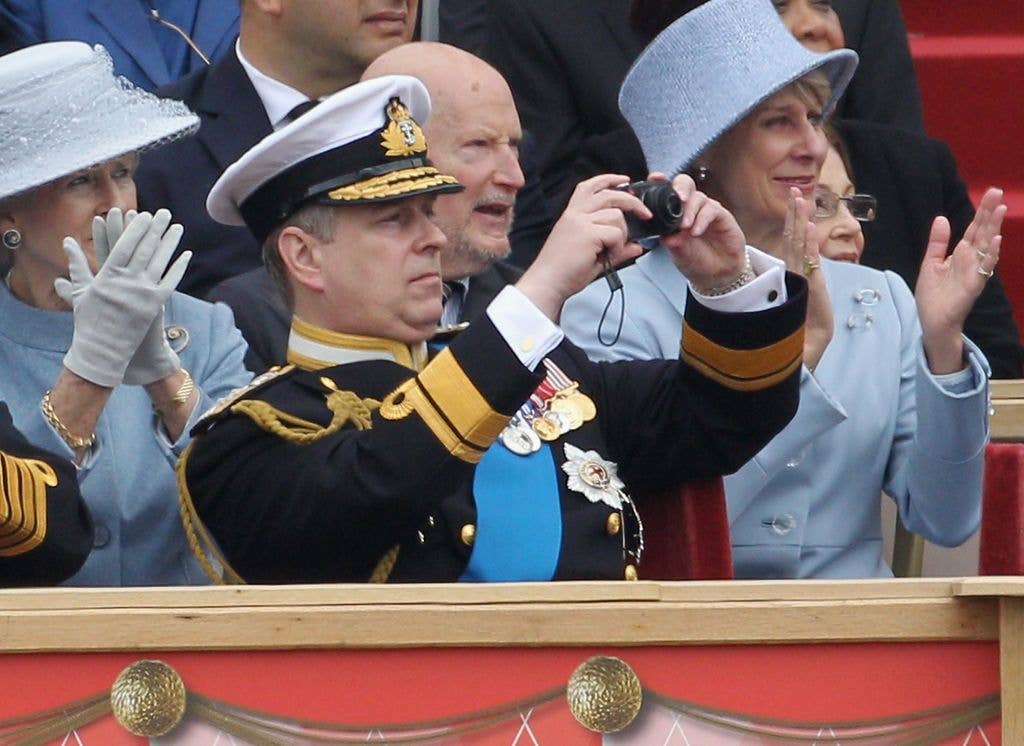 Andrew taking photos on a Leica compact camera as he attends the Armed Forces Parade 