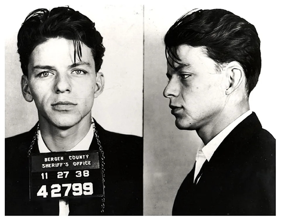 A black-and-white mugshot showing Frank Sinatra in a suit taken by the Bergen County Sheriff's Office, with identification number 42799